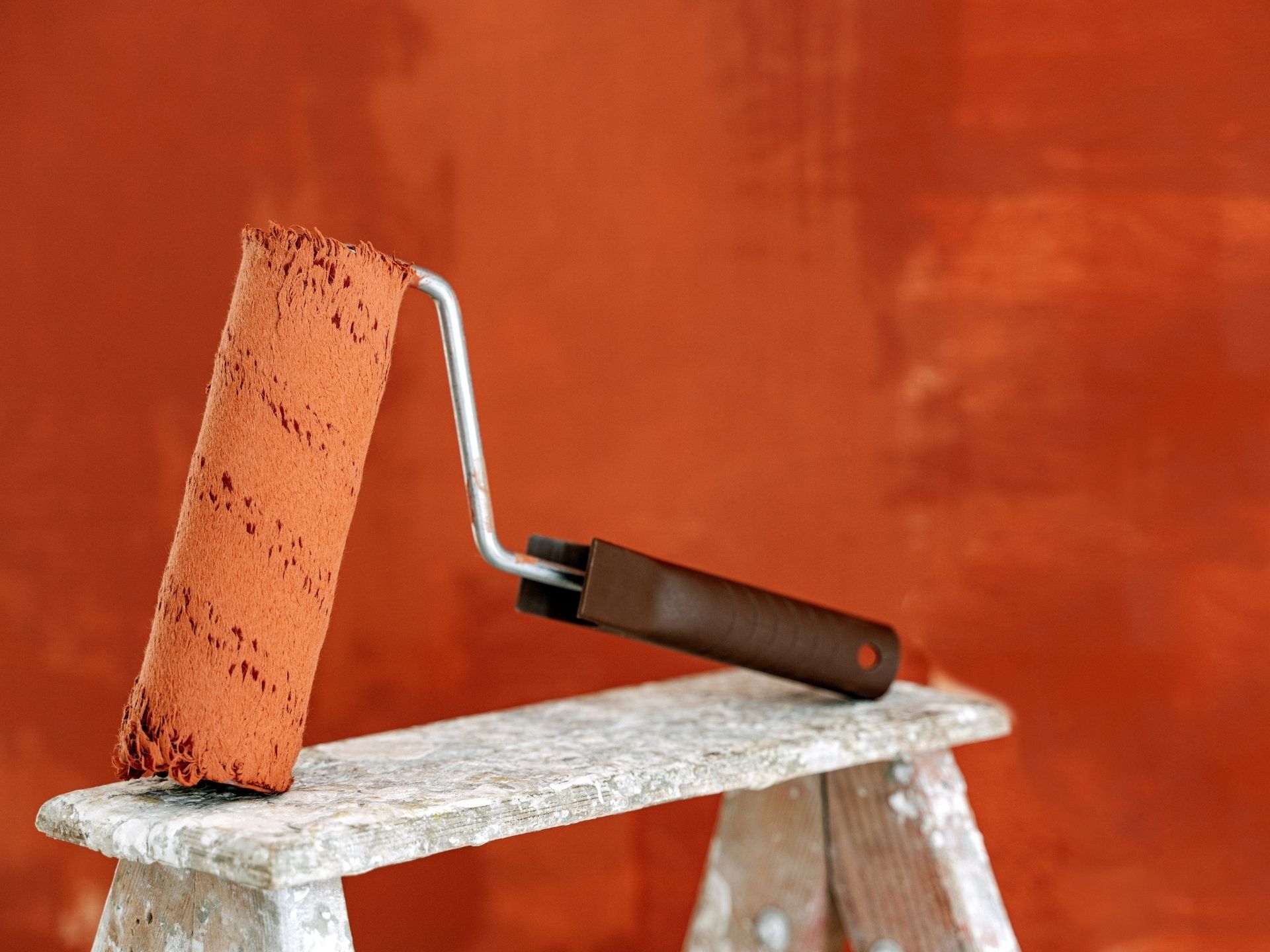 The Ultimate Guide to House Interior Painting in Wellington 3 House interior painting in progress using a roller on a ladder during the paint application stage for smooth and even coverage.